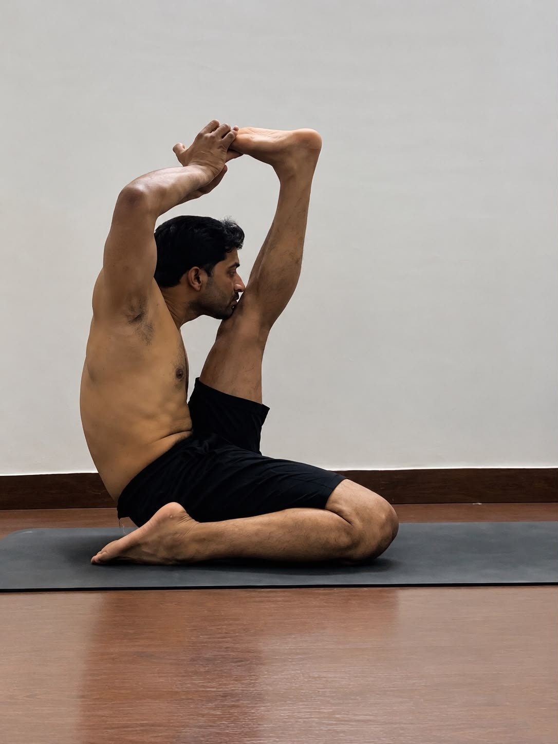 Abhishek demonstrating Krounchasana, a seated forward leg stretch