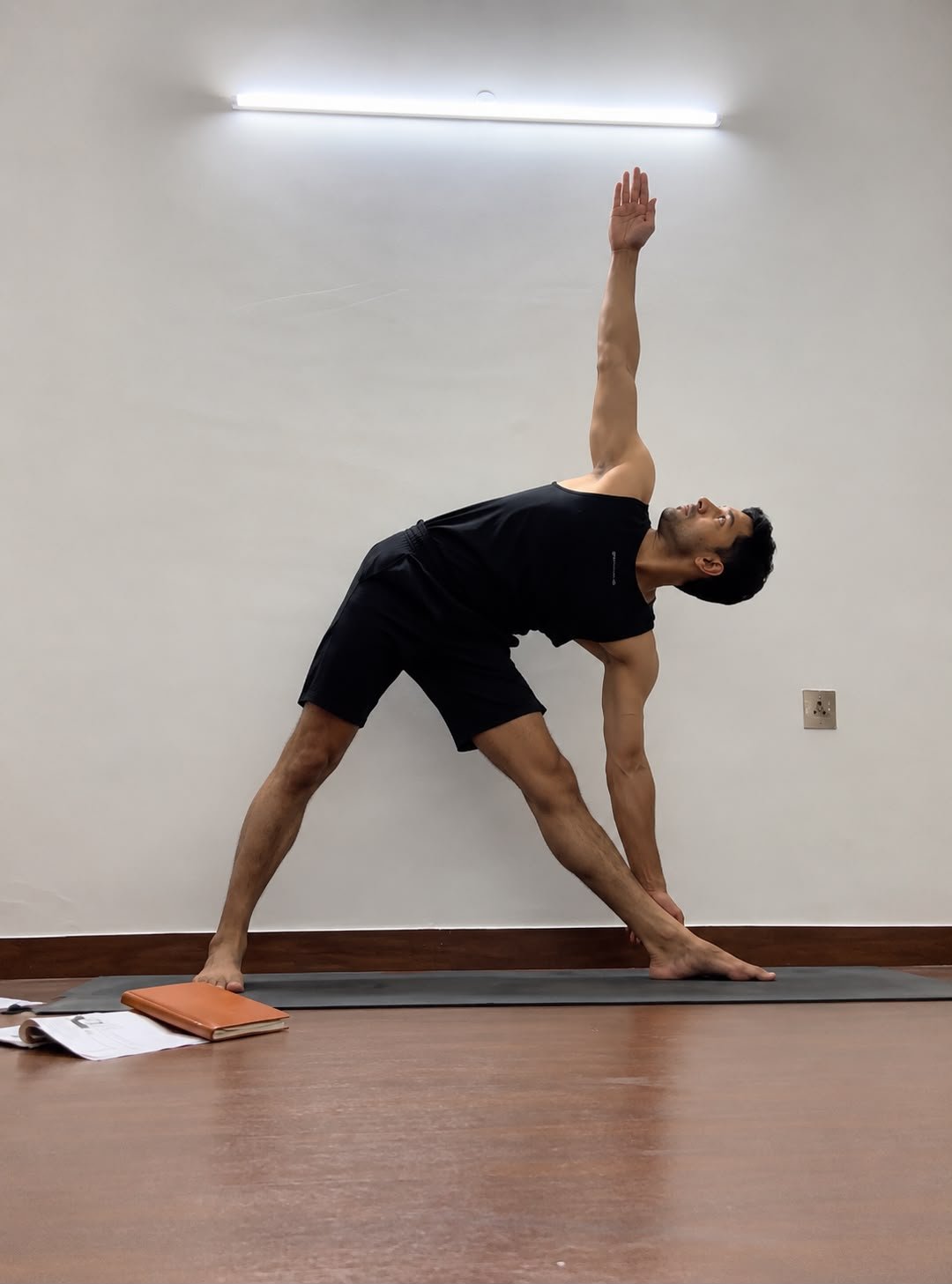 Abhishek demonstrating Trikonasana, the triangle pose