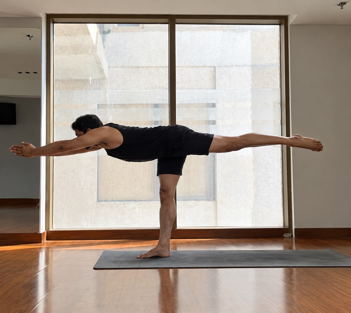 Abhishek demonstrating Virabhadrasana III, the Warrior 3 balance pose